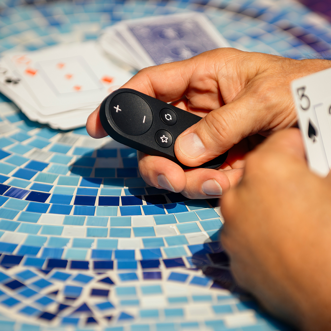 Man smiling using his phone and drinking coffee